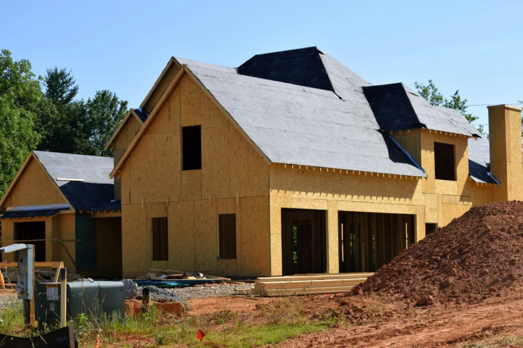 House under construction with roof sheathing and exposed framing