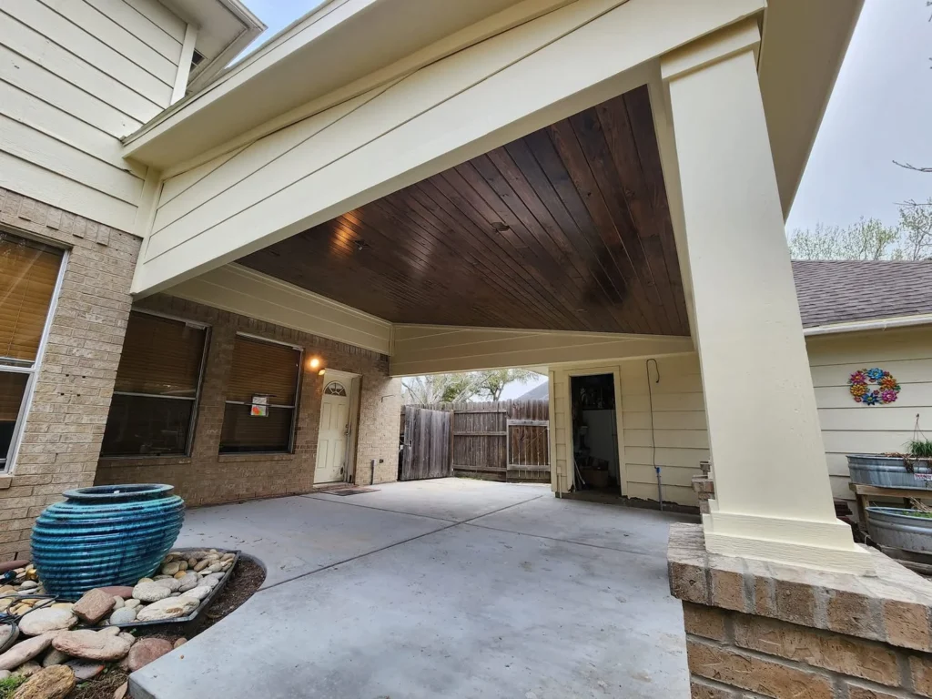 Large covered carport with wood ceiling and recessed lighting