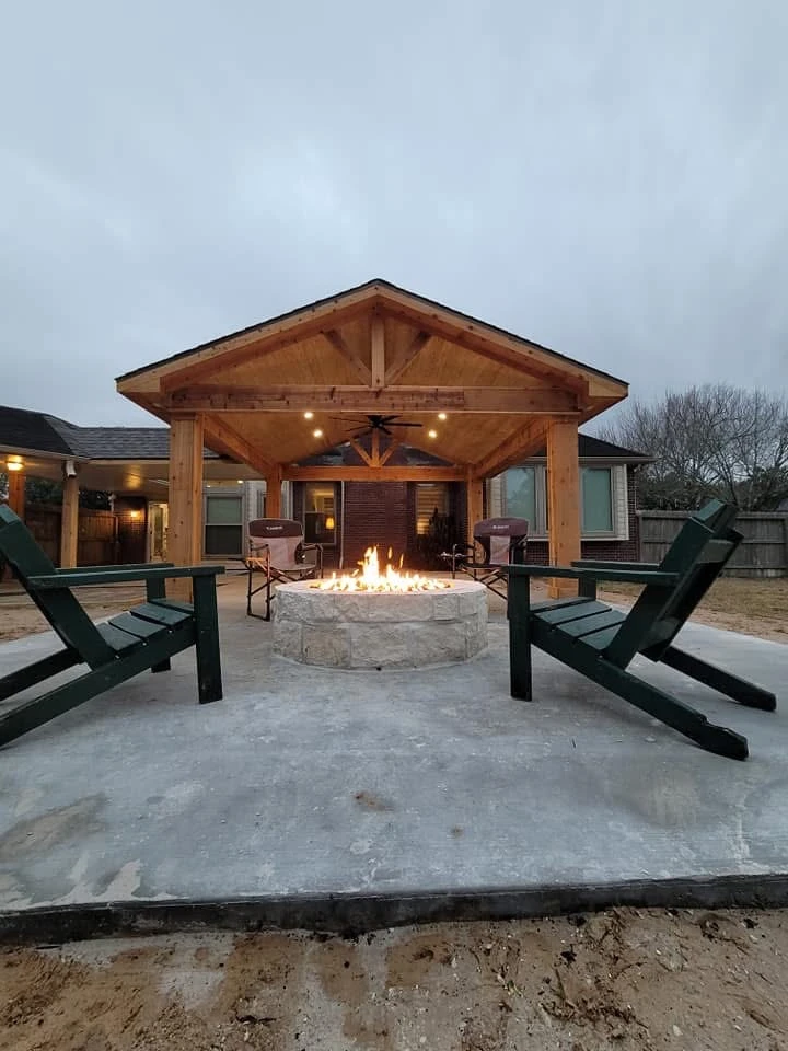 Covered outdoor patio with fire pit and lounge chairs
