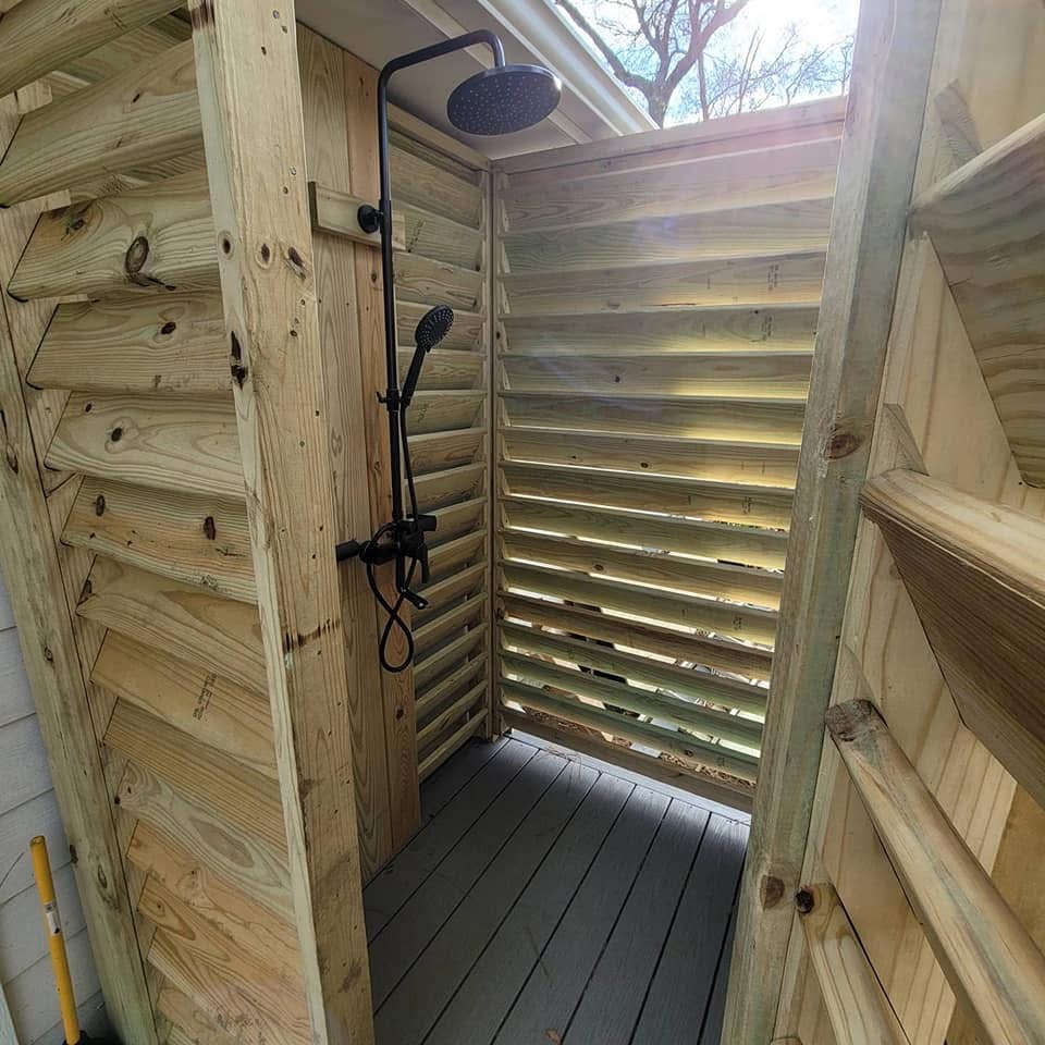 Wooden privacy shower enclosure for outdoor pool area