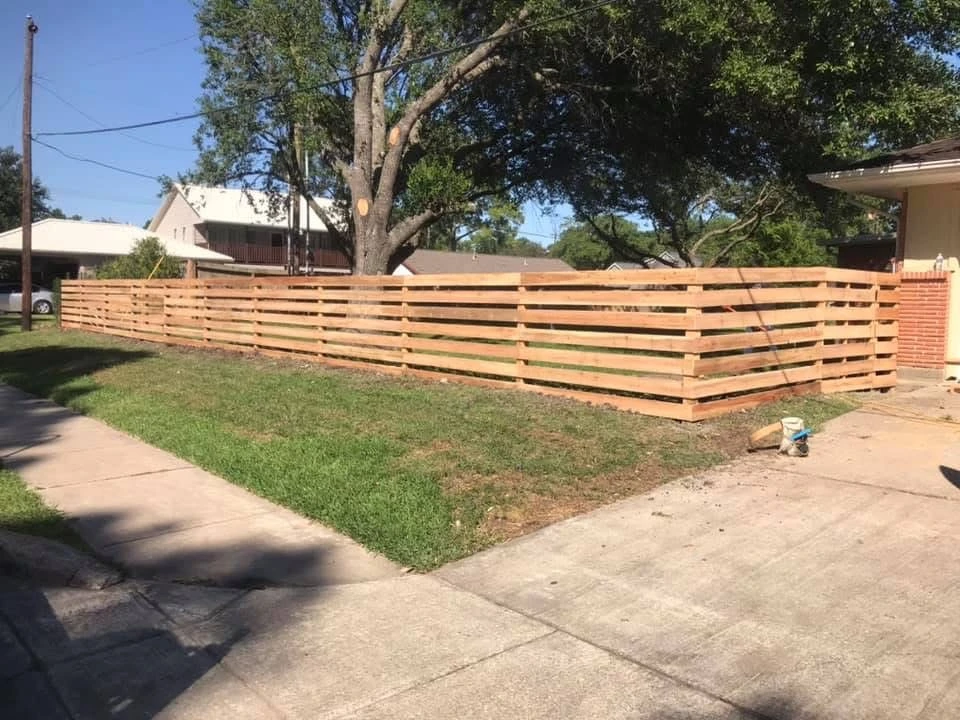 Horizontal slat wood fence in residential backyard