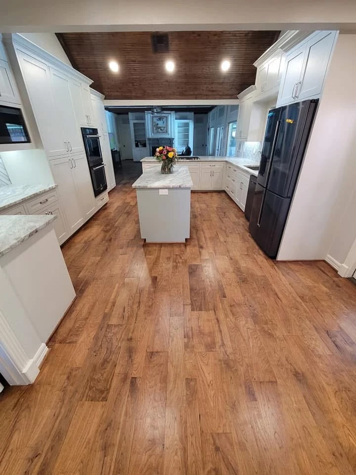 Open kitchen remodel with hardwood flooring and center island