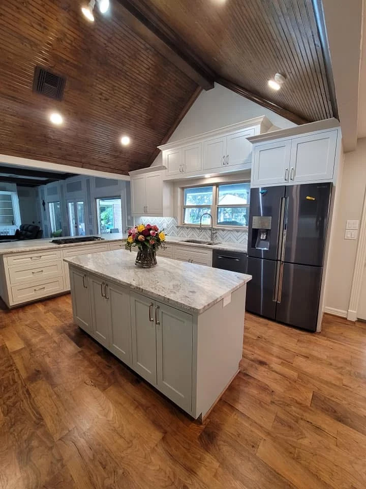 Modern white kitchen with island and stainless steel appliances