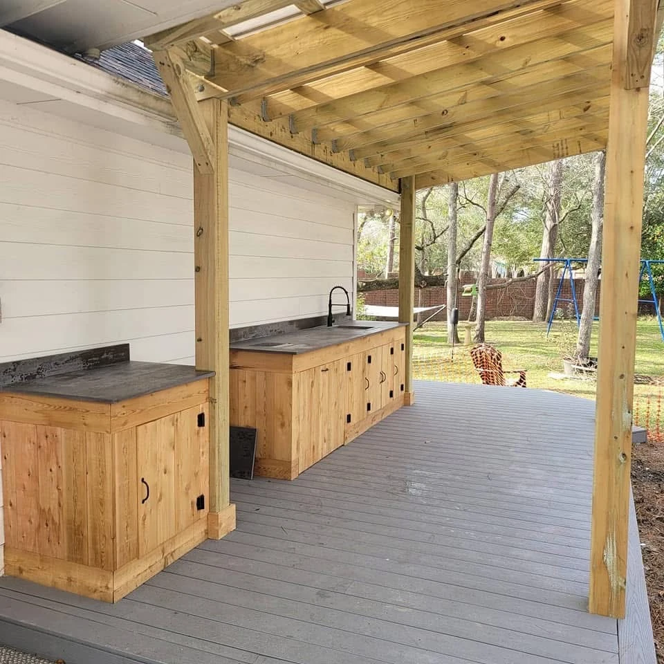 Covered wooden outdoor kitchen with natural wood cabinetry