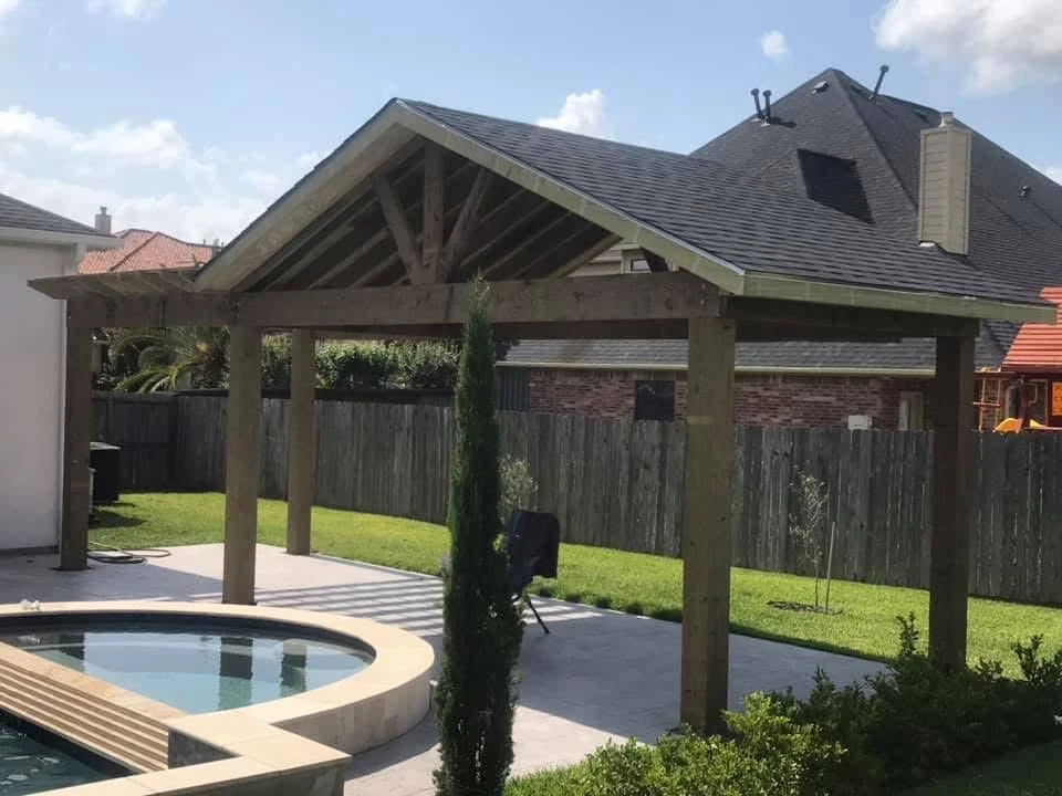 Luxury backyard with pergola-covered seating area near swimming pool