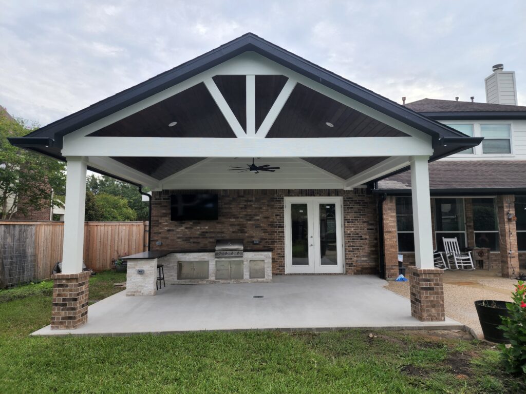 Custom front porch with decorative gable beams and stone columns
